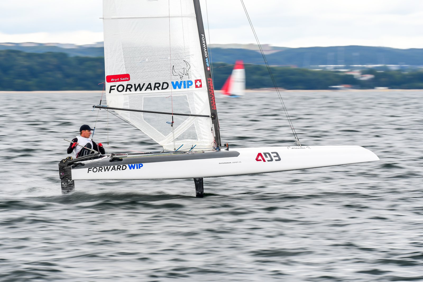 Tymoteusz Bendyk flying on A-Class foiling catamaran